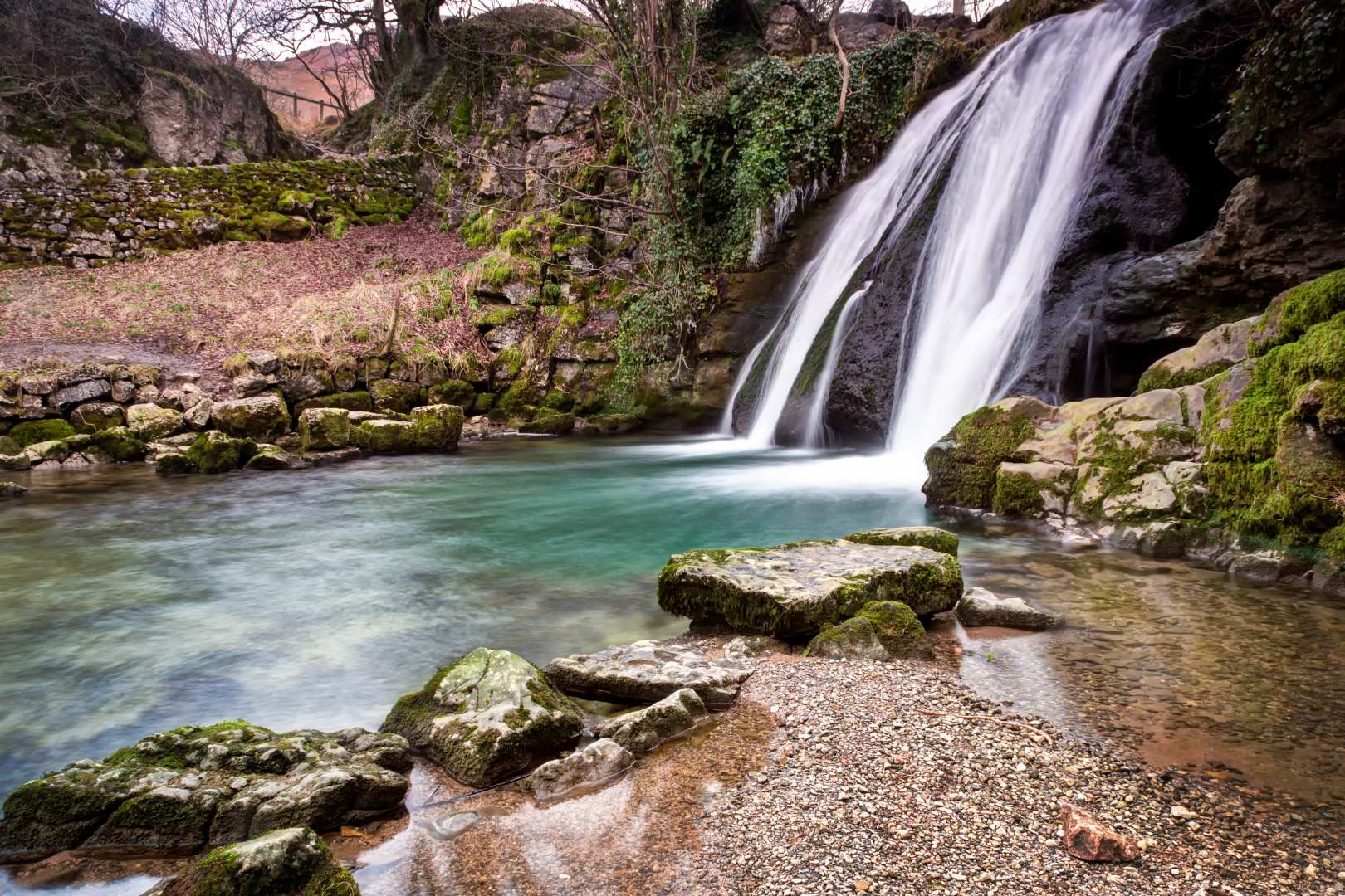 A waterfall tumbles into a pool at Janet's Foss in Yorkshire